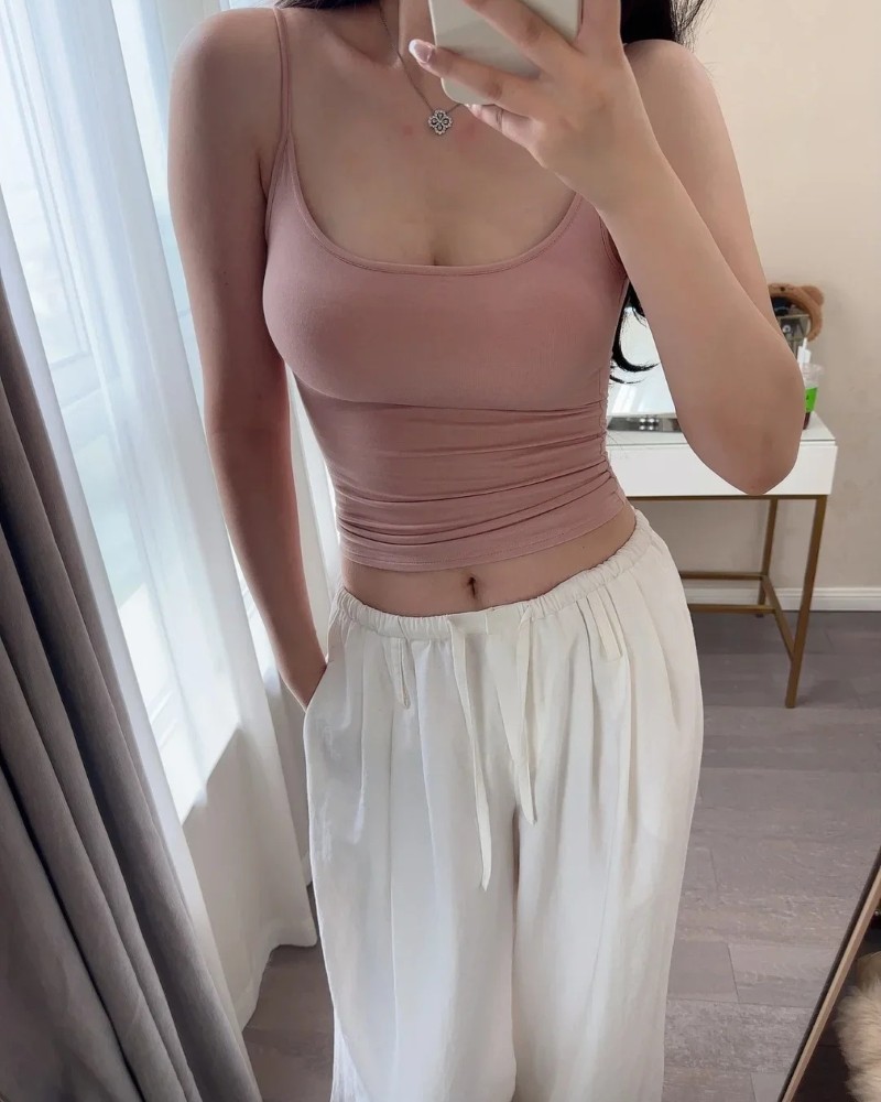 Cô gái mặc áo croptop tím tạo dáng gần cửa ban công