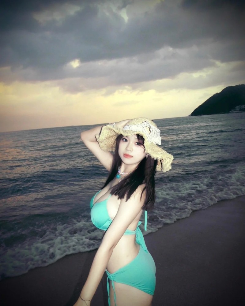 Người mẫu pose cạnh biển với đường cong nổi bật