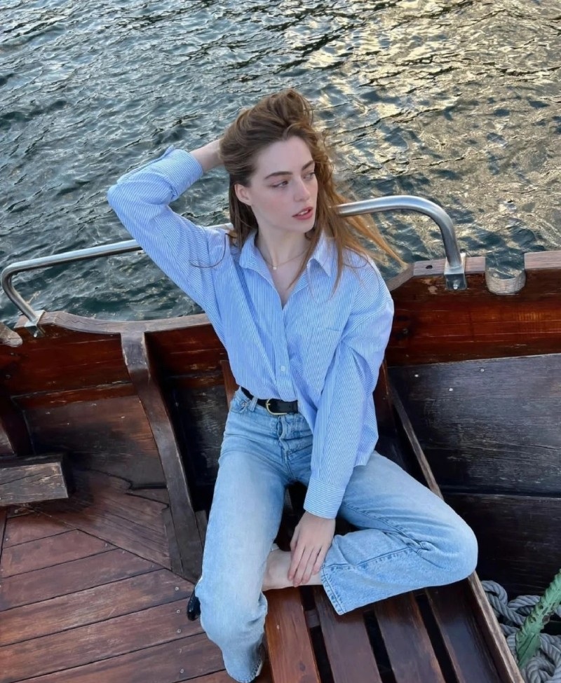 Nàng diện áo sơ mi ngồi bên bờ sông