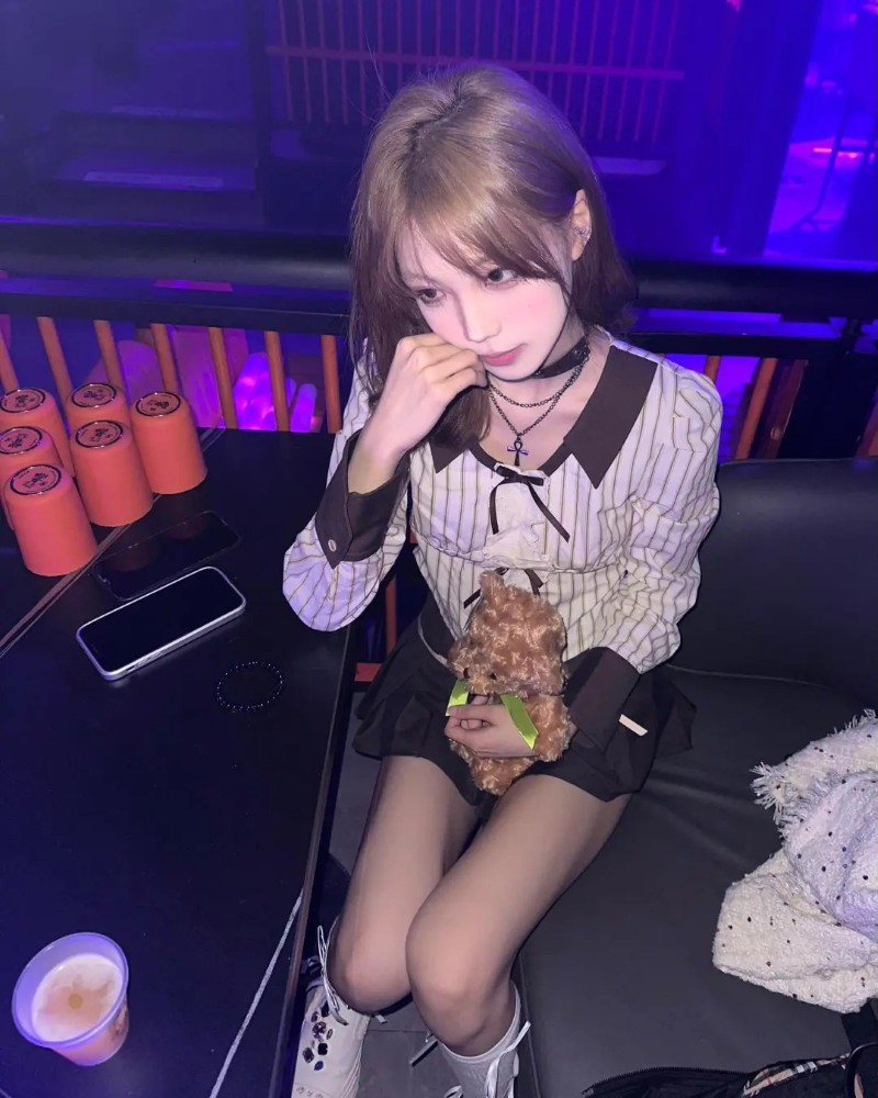 cô gái tạo dáng với ly nước trên tay