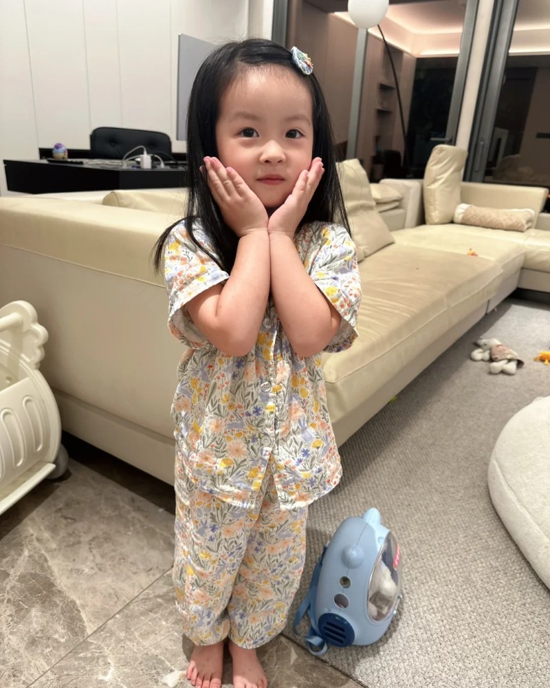 bé gái ngồi sàn chơi với đồ chơi